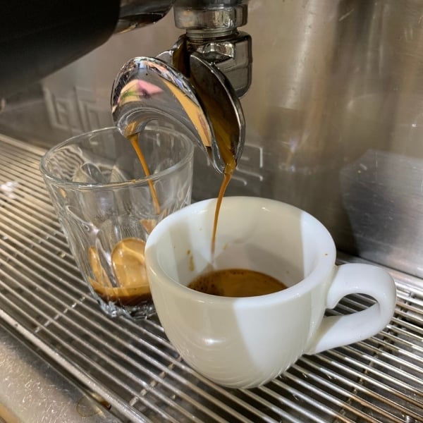 Slow dripping espresso extraction flow causing harsh bitter coffee notes